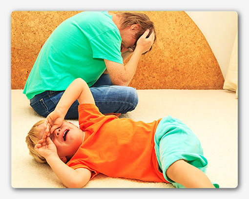 difficult parenting concept – crying child, tired father